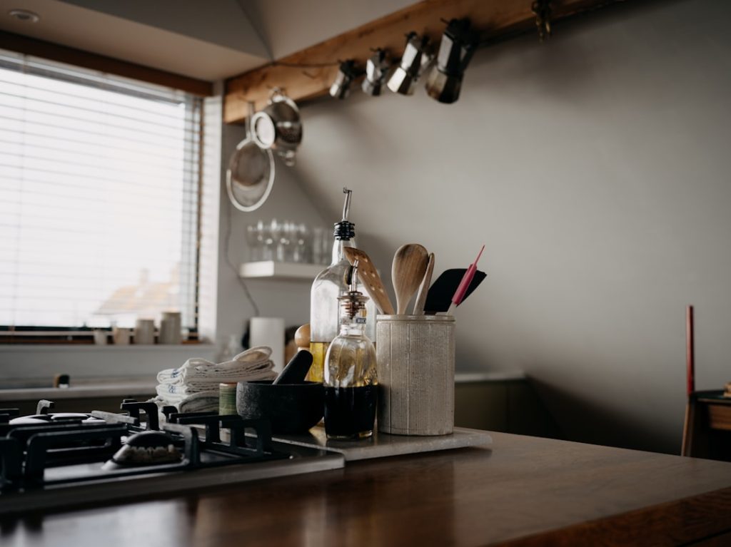 kitchen-counter-with-cooking-utensils-and-bottles-y-dkn7bspqk